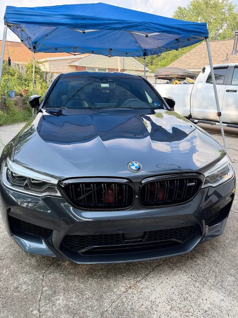 BMW with high-gloss paint reflections during a mobile ceramic coating appointment